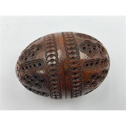 Three 19th century coquilla nut pomanders or flea catchers, two of egg shaped form and the third of barrel from with carved and pierced decoration and screw threaded join, largest H8cm