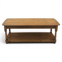 Ercol -  dark elm corner TV stand and coffee table, TV stand with drop triangular leaf, over open recess above a single drawer (H 47cm, D 44cm with leaf 79cm, W 73cm,  the coffee table with chamfered rectangular top with full length undertier, raised on turned supports (H 43cm, D 54cm, W 115cm) 