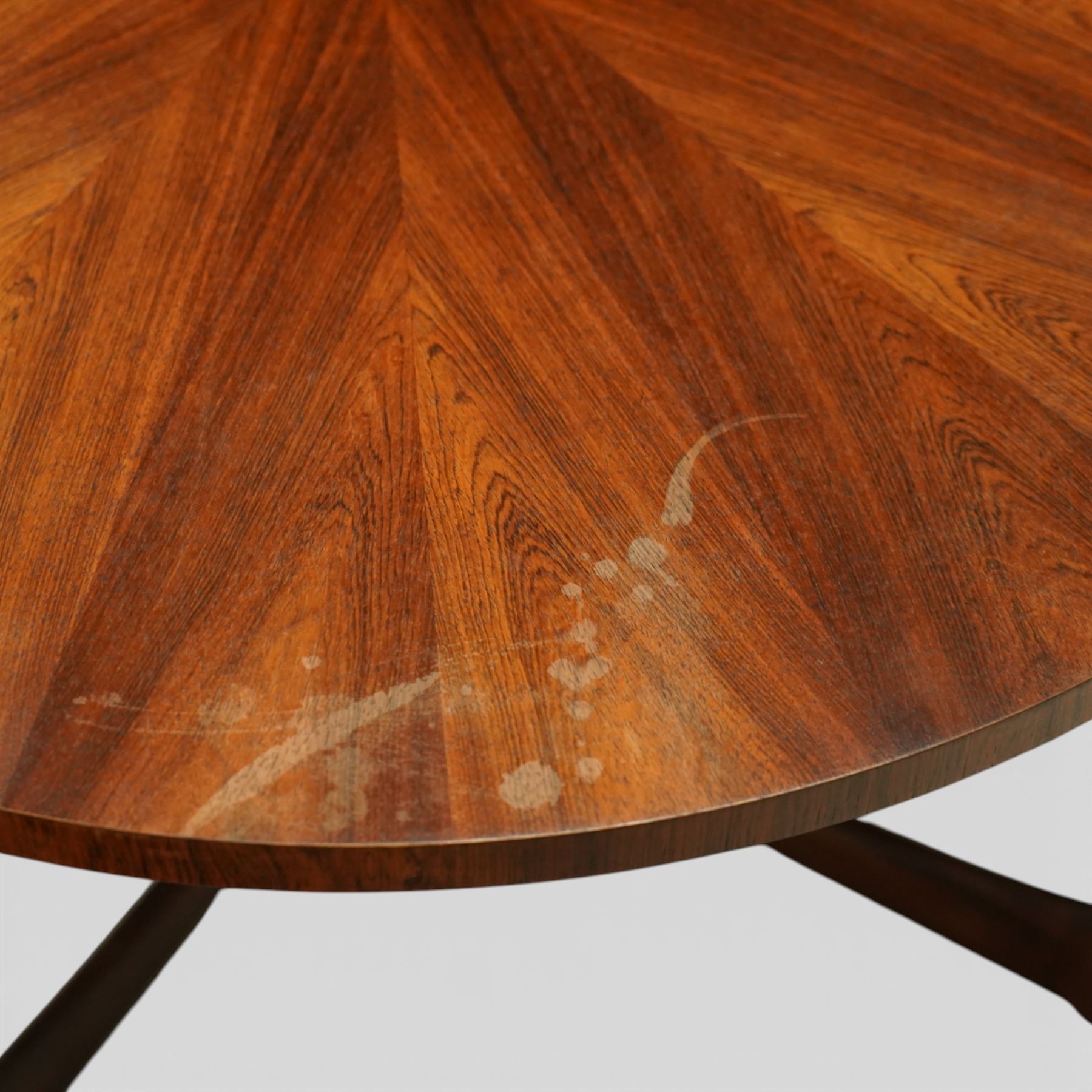 McIntosh of Kirkcaldy - Mid 20th century circular teak coffee table, circular top with book-matched radial veneers forming a starburst pattern and plain edge, raised on four tapered supports united by a shaped stretcher frame