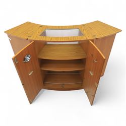 Turnbridge of London - Mid 20th century teak cocktail cabinet, with fold out top extending to 160cm, with twin doors revealing a shelved interior, the back with sliding glazed doors, raised on a recessed plinth base with castors