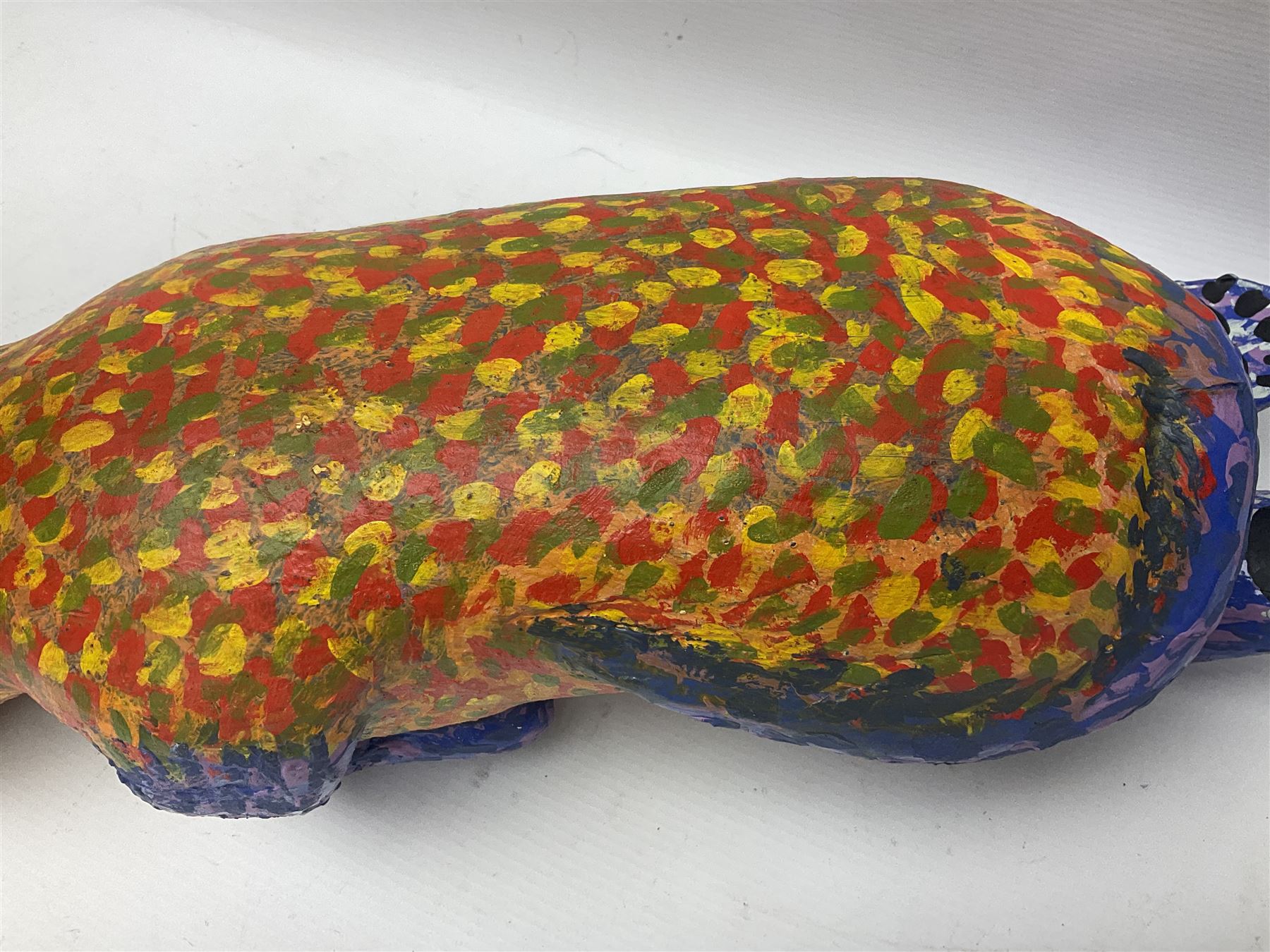 Helen Skelton (British 1933 – 2023): Two carved wooden abstract sculptures, one modelled as a dog, the other modelled as a bear, both with painted stippled decoration, largest H20cm. Born into an RAF family in 1933 in Kent and travelled the world extensively during her childhood. After settling in Bridlington, Helen immersed herself in painting, textiles, and wood sculpture, often inspired by nature's beauty. Her talent was showcased in a one-woman show at Sewerby Hall and recognised with the sculpture prize at Ferens Art Gallery in 2000. Sadly, Helen’s daughter passed away from cancer in 2005. This loss inspired Helen to donate her sculptures to Marie Curie upon her passing in 2023.