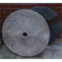  Two circular mill stones, one with cast iron back, D79cm max (2)  