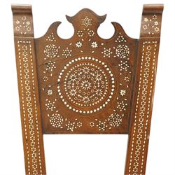 19th century Syrian olive wood and ivory inlaid chair, the shaped back and cresting above a panel centred by a circular starburst roundel within geometric and foliate marquetry and stringing, the tapering uprights and frame extensively inlaid with repeating ivory motifs, the octagonal seat similarly decorated, raised on splayed legs united by H-stretcher with further inlaid ornament