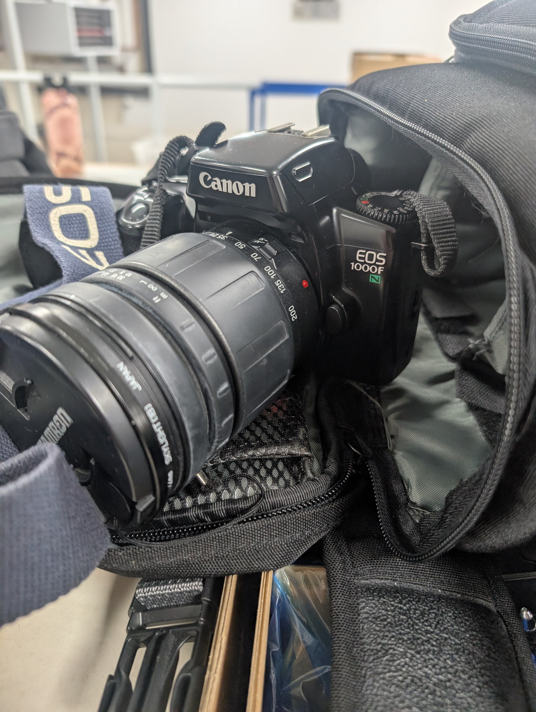 Collection of cameras and photography equipment, including Canon EOS 1000F DSLR, Fujifilm S9500, Canon EOS 10, lenses, filters, tripods, etc, in three boxes