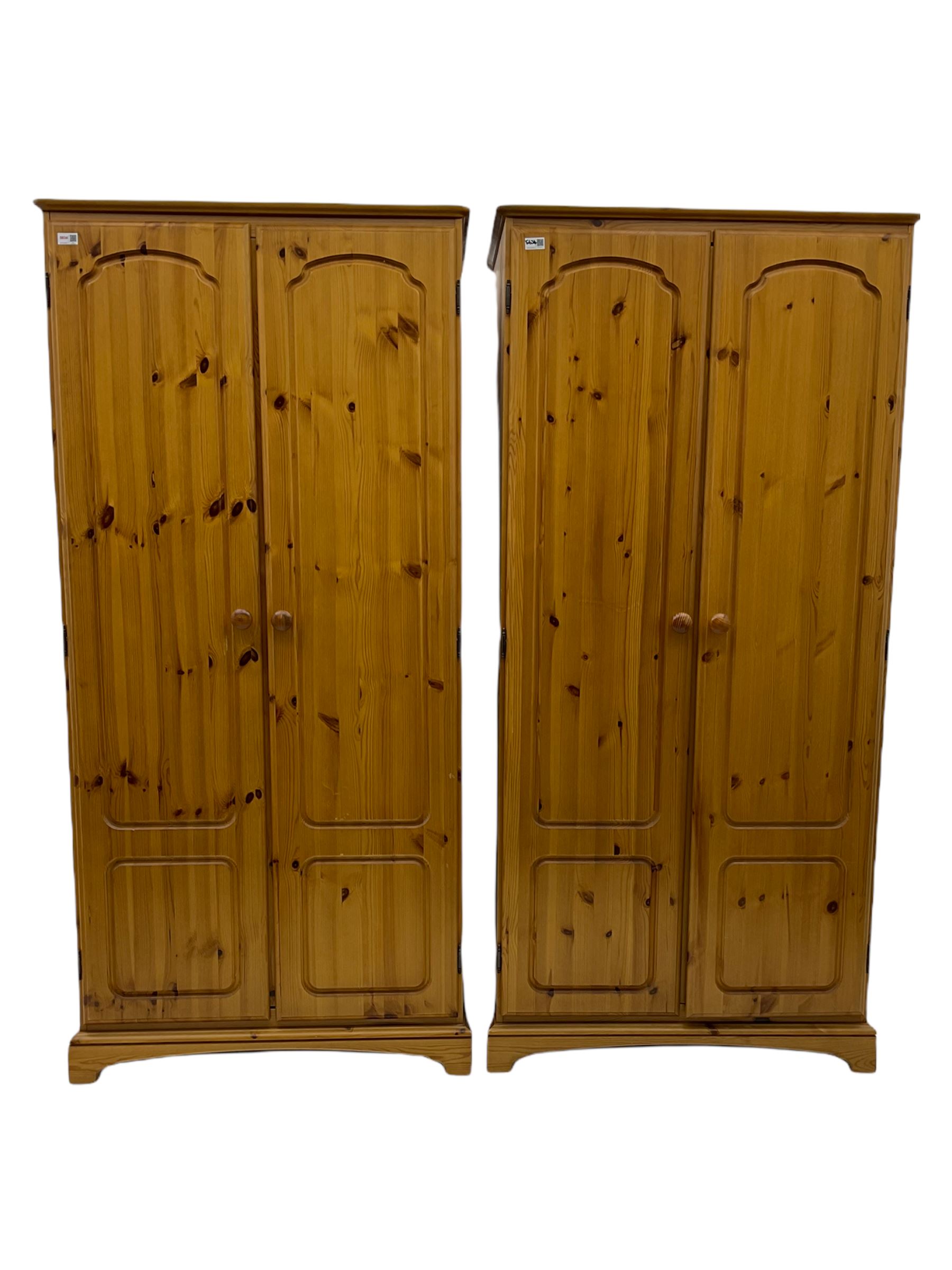 Two modern pine double wardrobes, two three drawer bedside chests and a