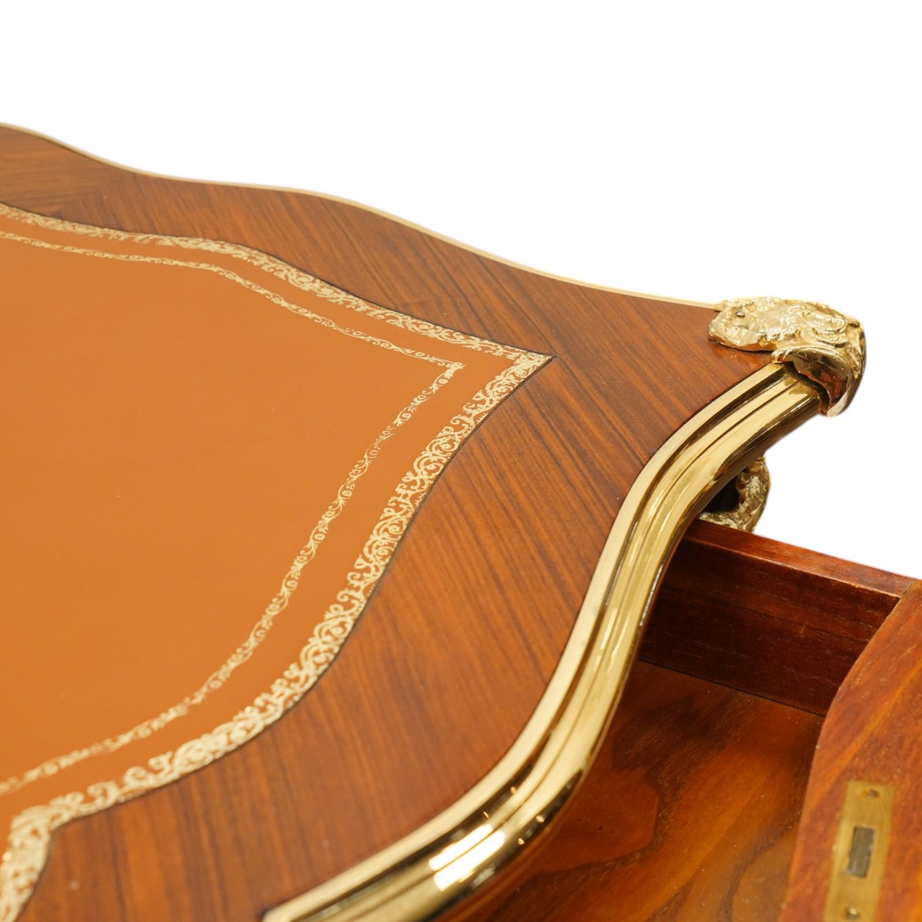 Baggio Anciens Meubles - Italian Louis XV style kingwood and gilt metal mounted bureau plat or writing desk, the shaped rectangular top with inset leather writing surface with gilt metal edge, above three shaped frieze drawers with gilt metal handles, raised on cabriole supports with gilt cartouche mounts to the knees and scroll feet