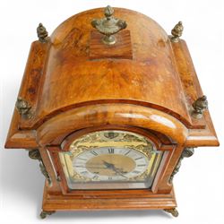 German-early 20th century mantle clock c1910, in a walnut case with a break arch top and decorative cast brass finials, brass silk backed sound frets to the sides and a glazed break-arch door flanked by a pair of cast brass caryatid, on a dee ogee moulded plinth and raised on splayed paw feet, brass dial with cast spandrels and a matted dial centre, silvered chapter ring with Roman numerals, gothic steel hands and a conforming pendulum regulation dial to the arch, two train going barrel movement with rack striking, sounding the quarters on two gongs and the hour on one, With Pendulum and key.
