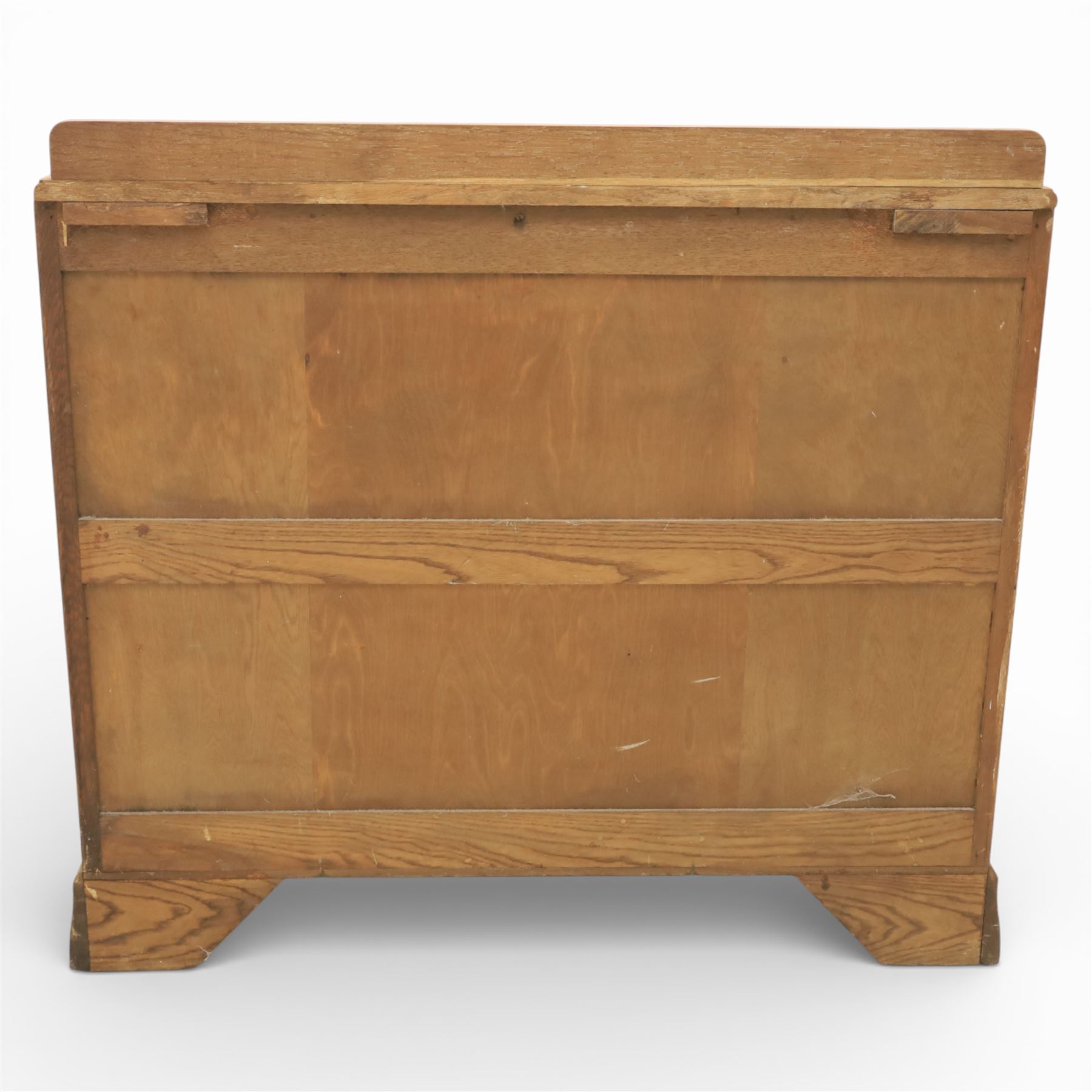 Early 20th century Art Deco bedroom suite, comprising double wardrobe, dressing table and chest of drawers, constructed in walnut with figured veneers and geometric banding, the wardrobe with arched top and panelled doors enclosing a fitted interior, the dressing table with rectangular top below a three panel mirror arrangement, fitted with two short over two long drawers, the chest with three short and three long drawers, each piece fitted with faceted handles and raised on shaped feet
Wardrobe (H 177cm, D 46cm, W 112cm)
Chest (H 85cm, D 48cm, W 92cm)
Dressing table (H 160cm, D 52cm, W 106cm)
