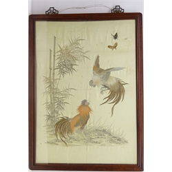  Chinese framed silk embroidered panel depicting two fighting cockerels beside bamboo and butterflies, on ivory ground, in hardwood frame H92cm x W65cm  
