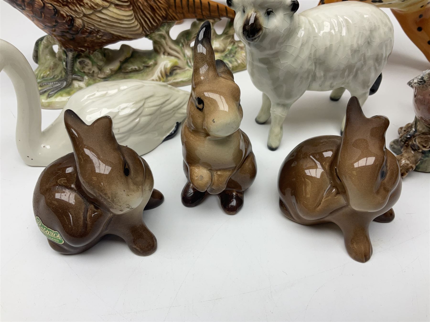 Group of Beswick figures to include leopard no 1082, rabbits, swan, pheasant no 1226 etc, all with marks beneath