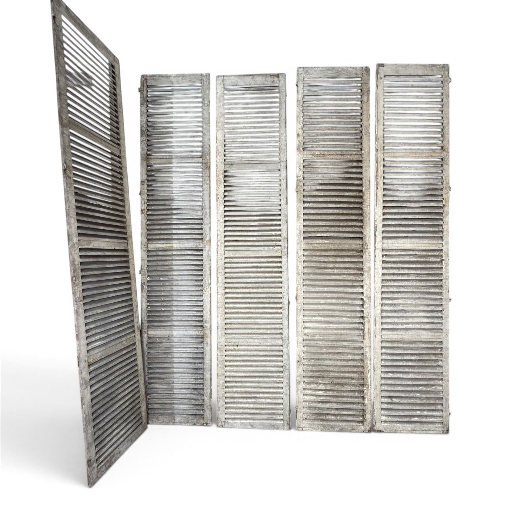 Five 19th century full height French Chateau louvre doors, pitch pine painted in cream finish, two having iron rod hinges, dimensions approx.