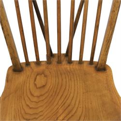 Traditional elm and beech Windsor dining chairs, each with hoop back and turned spindles over a shaped solid seat fitted with loose floral upholstered cushions, raised on turned tapering supports united by crinoline stretchers