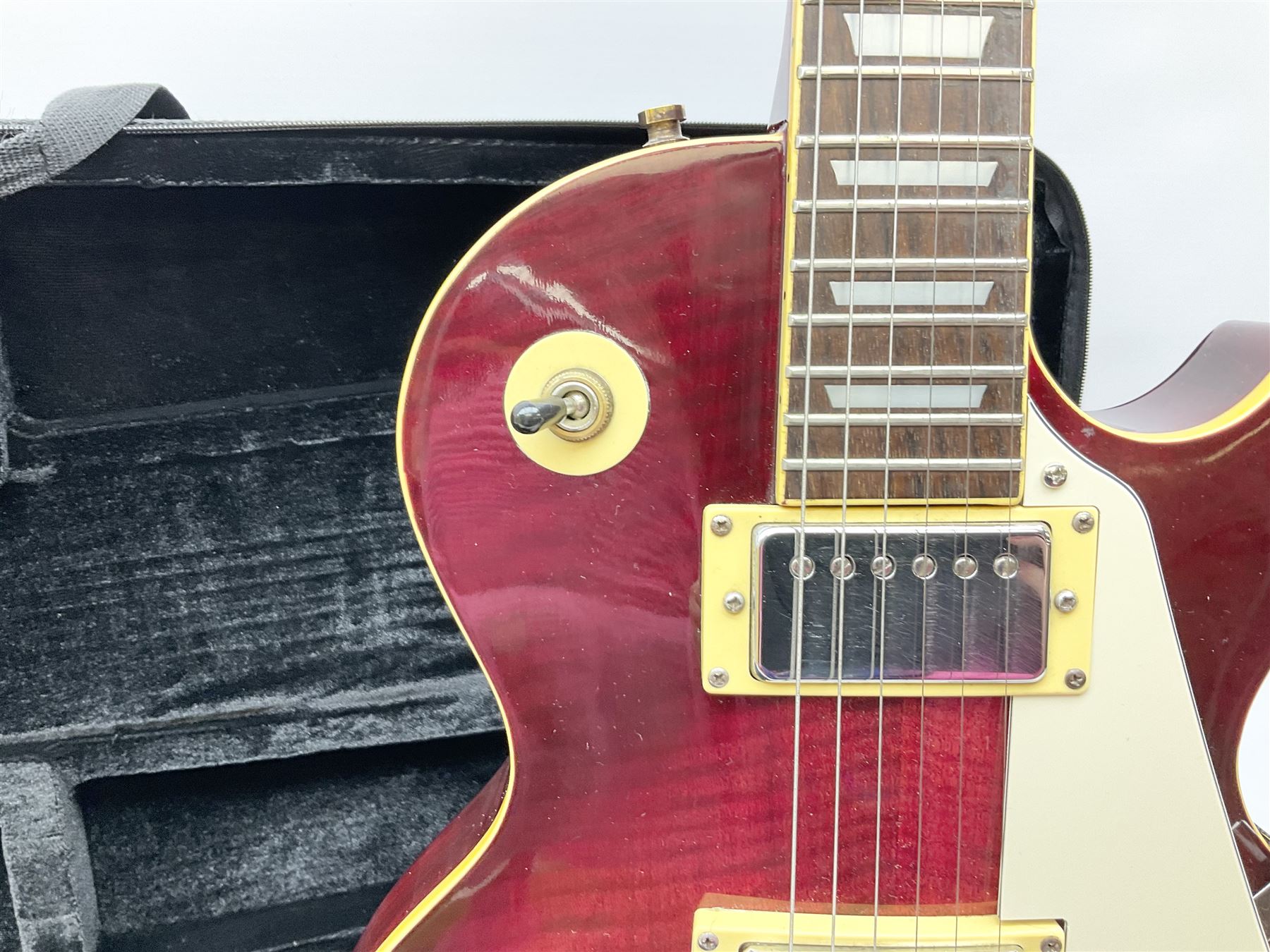 1980s Les Paul Epiphone limited edition cut-away electric guitar by Gibson, the burgundy coloured body with two pick-ups, volume and tone knobs and scratch plate, original tuning pegs, serial no.U6030215, 101cm overall; in modern Kinsman fitted carrying case