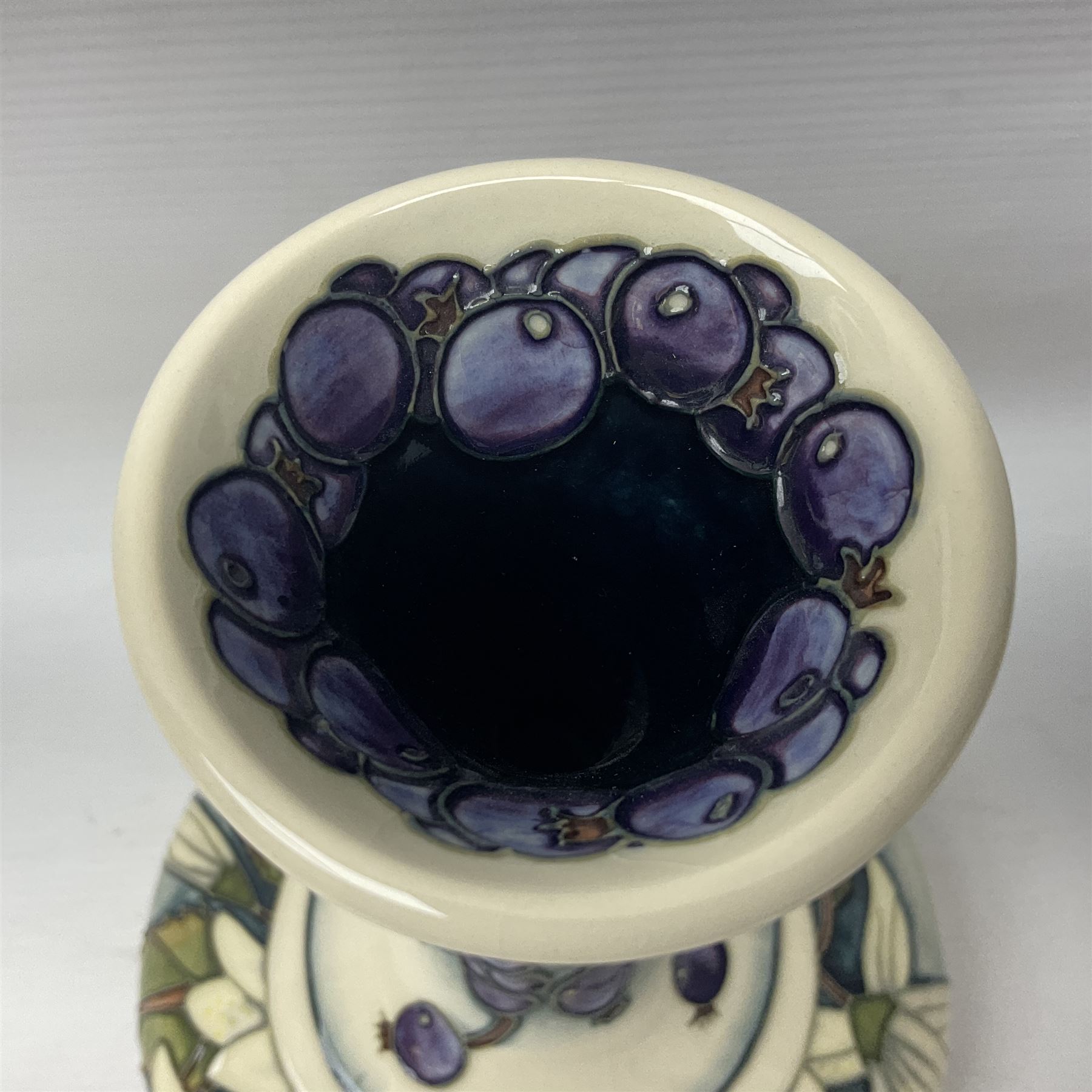 Moorcroft vase, of compressed form with a tall flared neck, decorated in the Juneberry pattern, circa 2000, H25cm