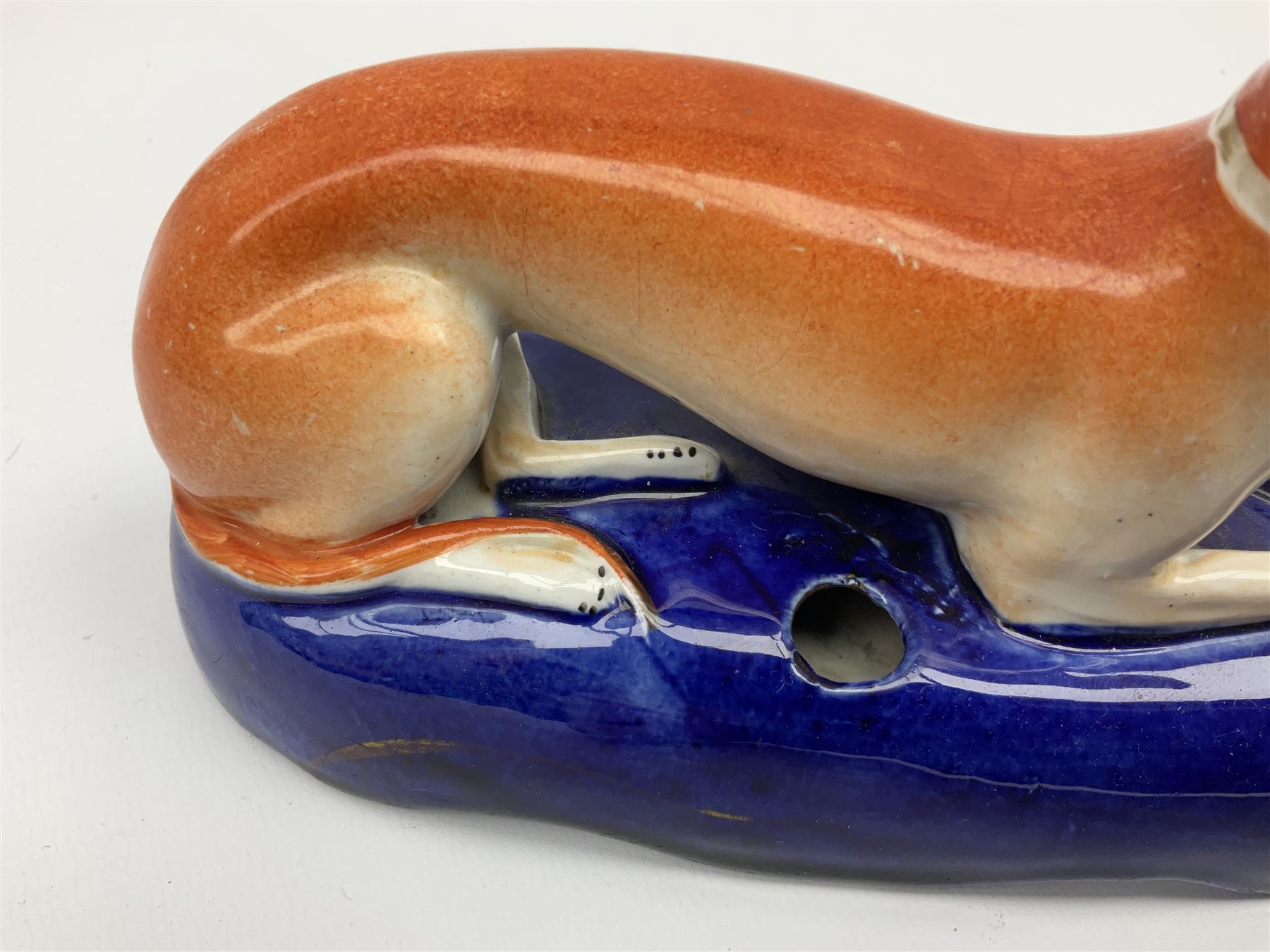 Pair of Staffordshire recumbent greyhound pen holders 