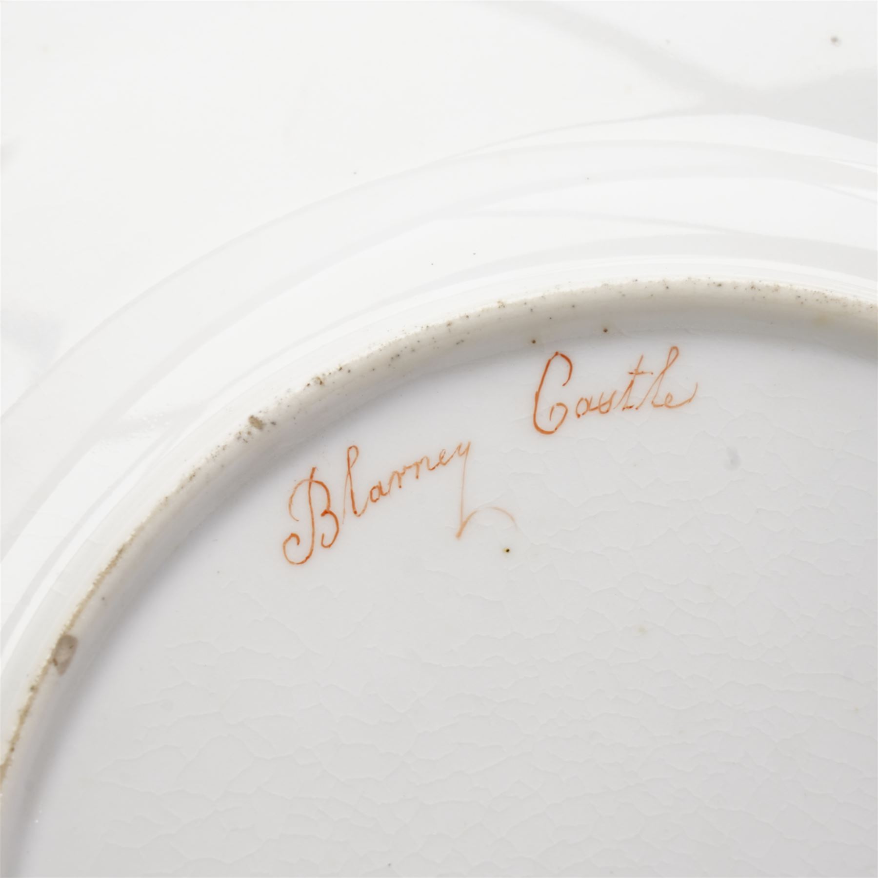 H&R Daniel Queen's shape porcelain plate, centrally painted with Blarney Castle, within a polychrome floral painted border, titled beneath, D25cm and another plate painted with a view of Warwick Castle (2)