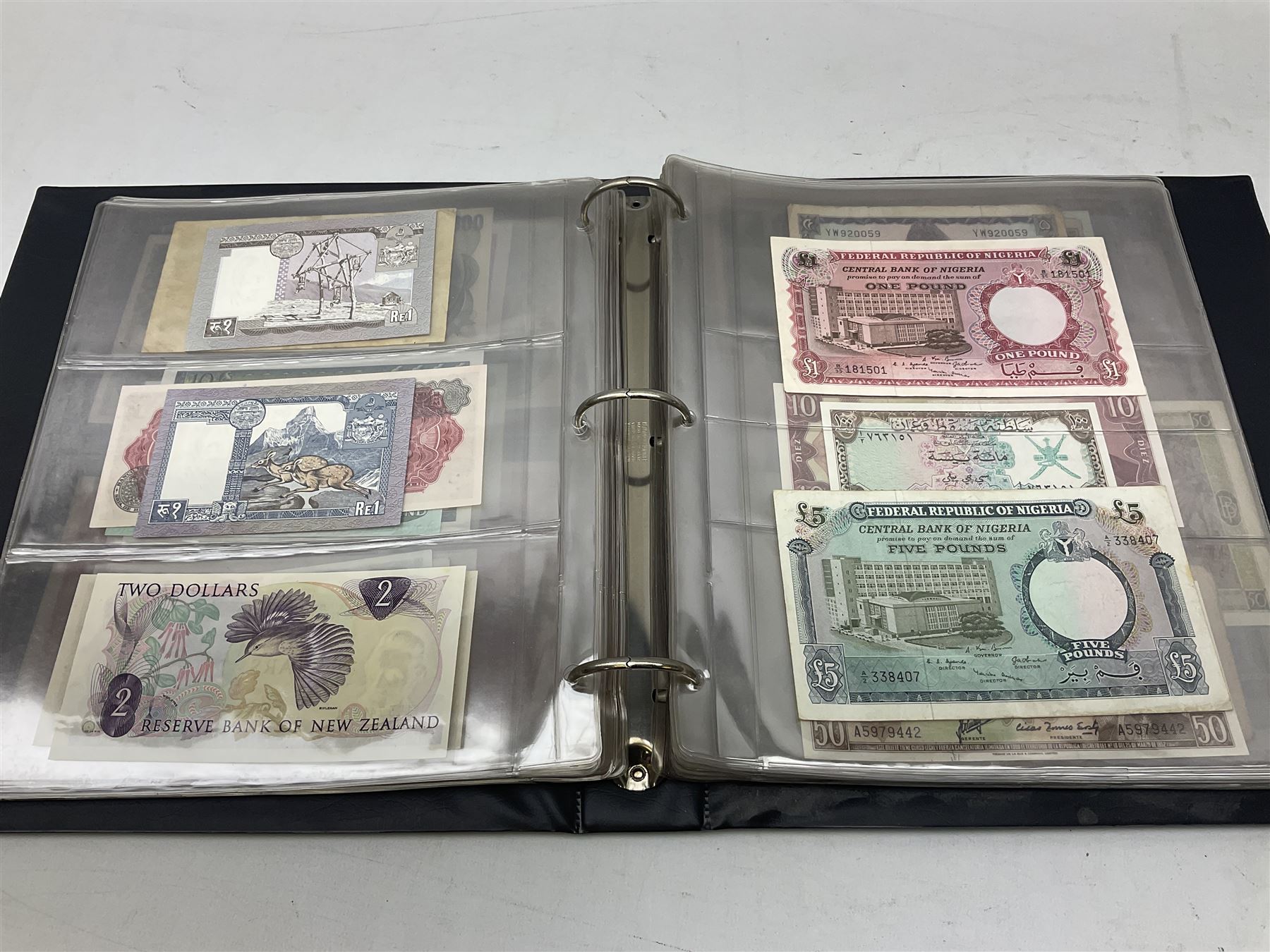 World banknotes, including Queen Elizabeth II The States of Jersey one pound 'DB202703', five pounds 'BB527762' and ten pounds 'AB651481', reserve bank of New Zealand two dollars '1L3 741894', King George V Straits Settlements one dollar 1st January 1935 'F/83 28924', various Bank of England notes etc, housed in two ring binder albums