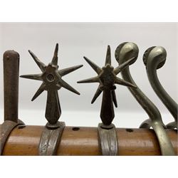 Pair of South American gaucho horse riding spurs with seven-spike rowels, possibly Chilean; and four other pairs of Maxwell type horse riding spurs displayed on an Edwardian purpose-made mahogany rack in the form of a stable saddle rack L37cm