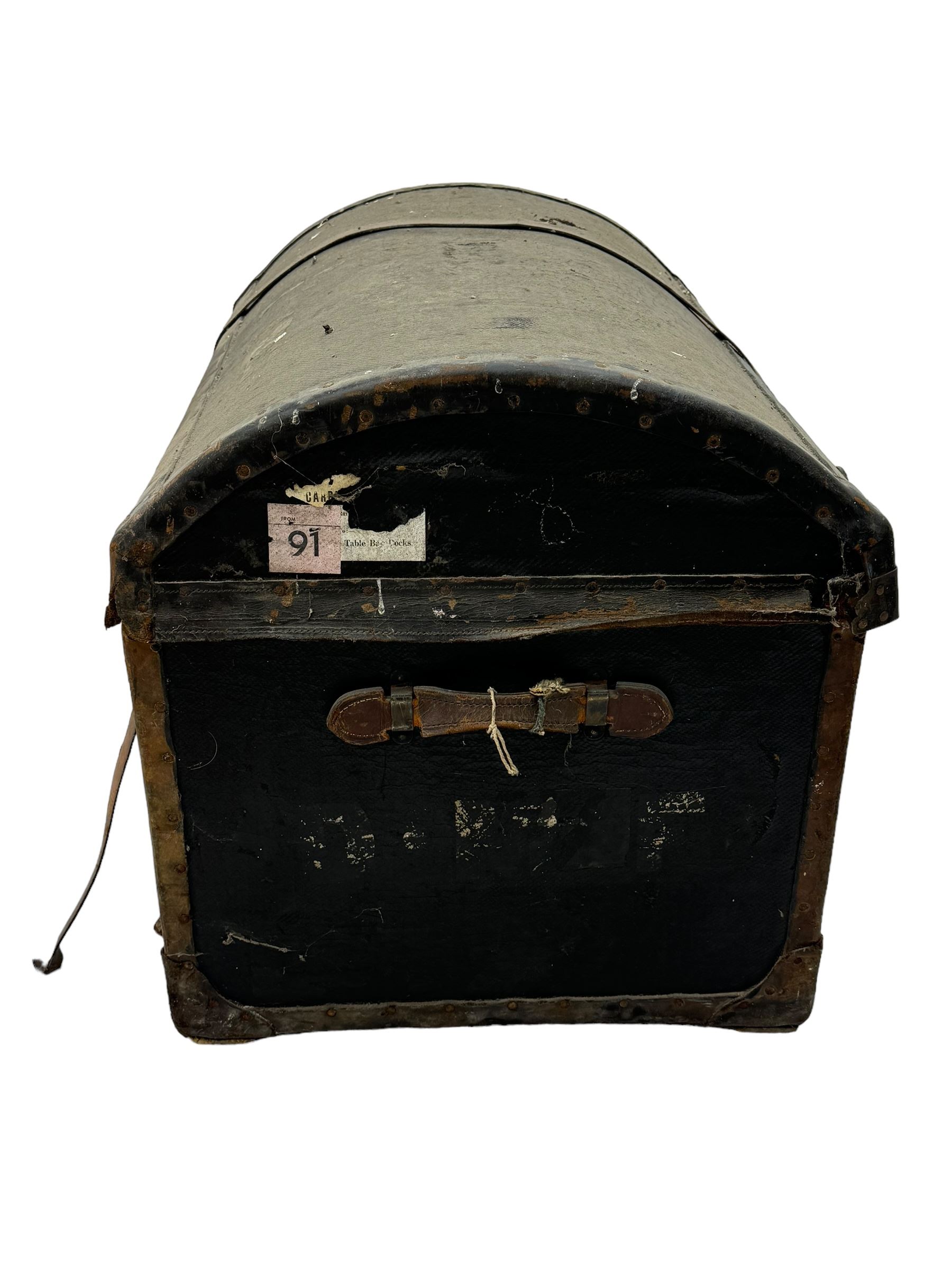 Early 20th century travel trunk, domed top with leather straps and metal rivet detailing, wooden frame with black canvas covering, interior lined with striped fabric, manufacturers mark to the inside 