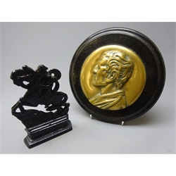  Cast bronze wall plaque, head and shoulder portrait of Wellington, mounted on ebonised oak circular base D23cm and a small cast iron fireside figure of Napoleon riding a horse (2)  