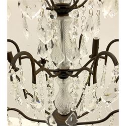 Contemporary bronze finish twelve branch chandelier, decorated with glass droplets 