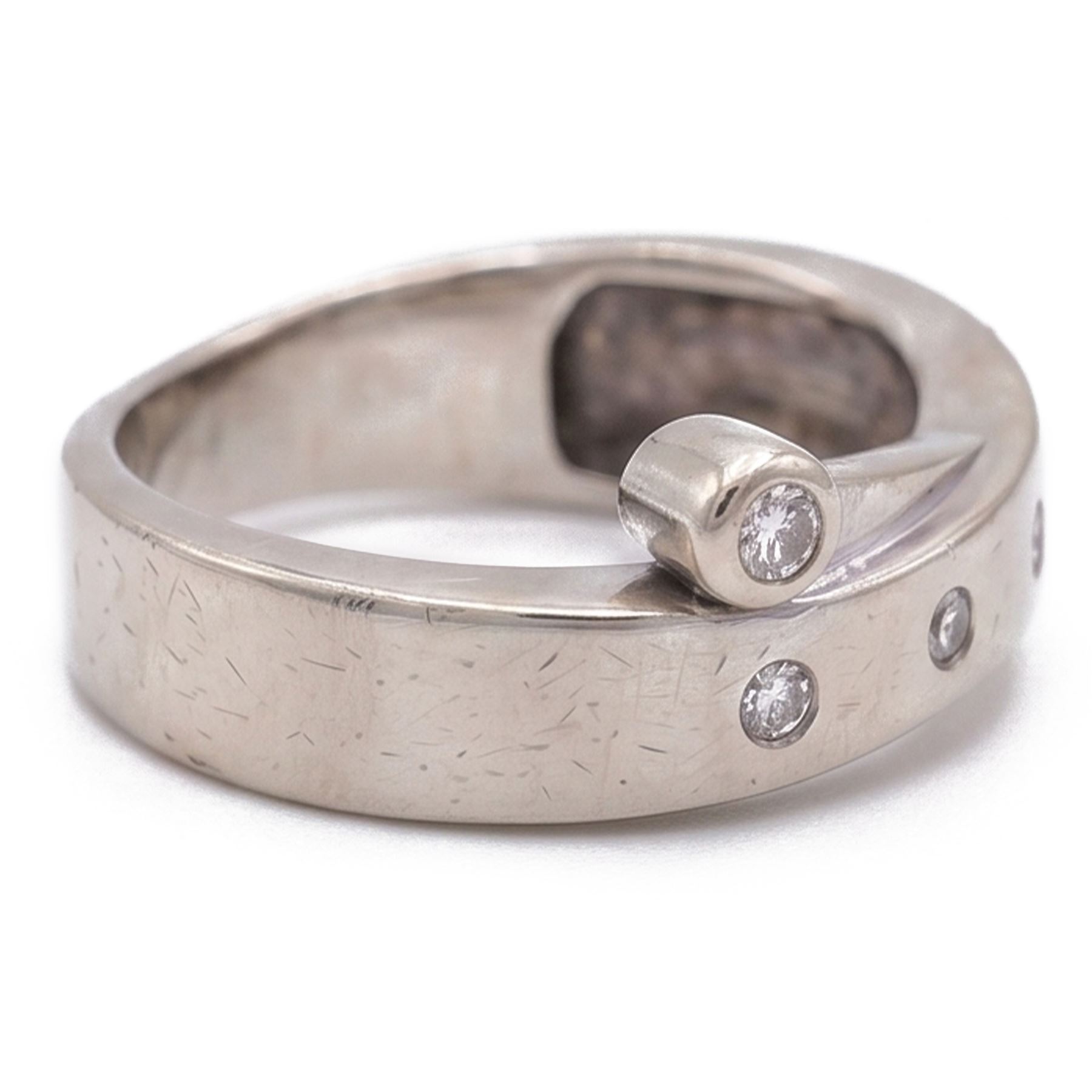 14ct white gold four stone diamond crossover ring, rubover and bezel set with four round cut diamonds, stamped 585