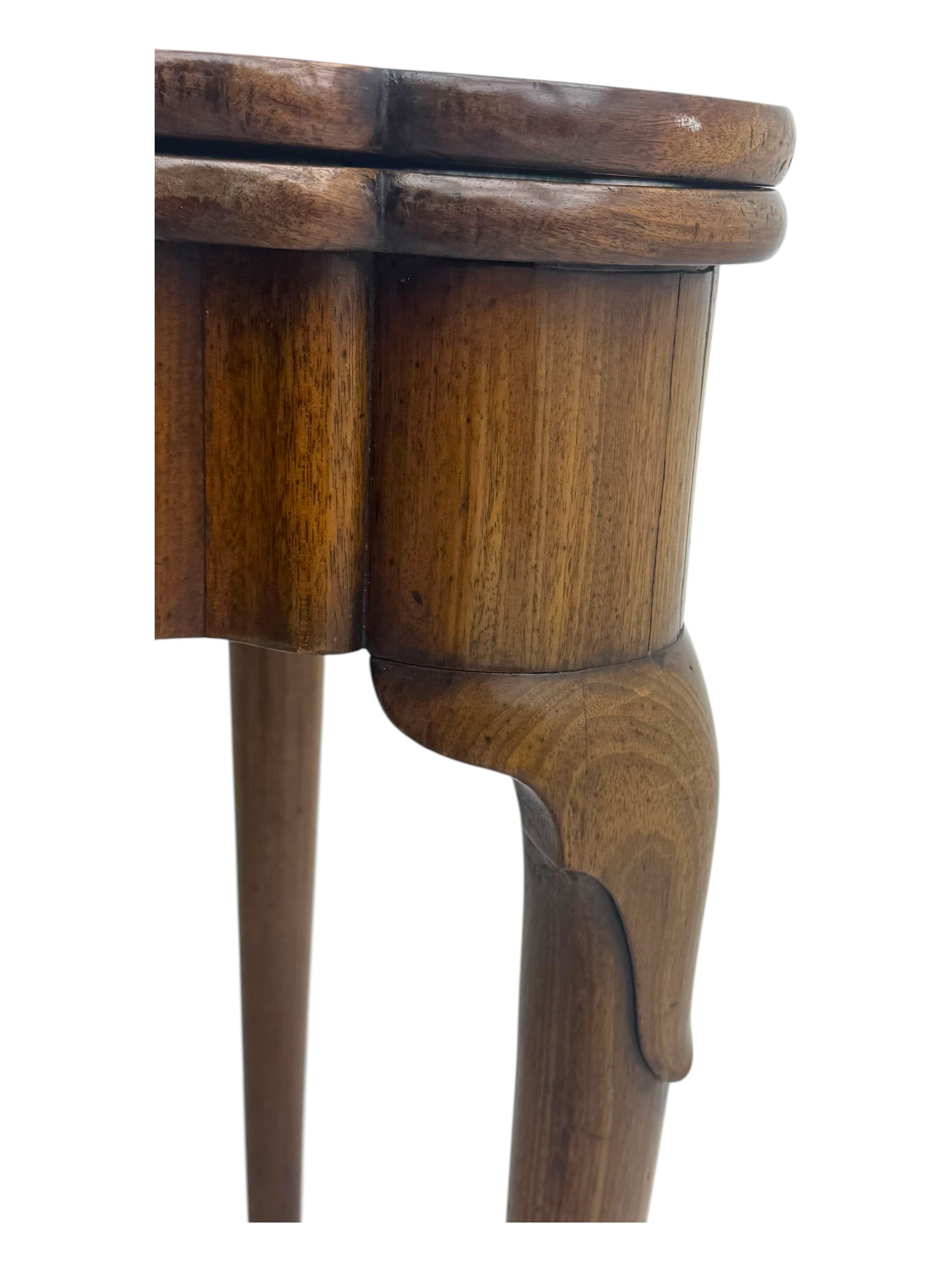 George III mahogany fold-top card table, shaped rectangular top opening to reveal a baize-lined surface, supported by a concertina pull-out concertina rear mechanism, raised on cabriole supports with foliate carvings terminating in pad feet