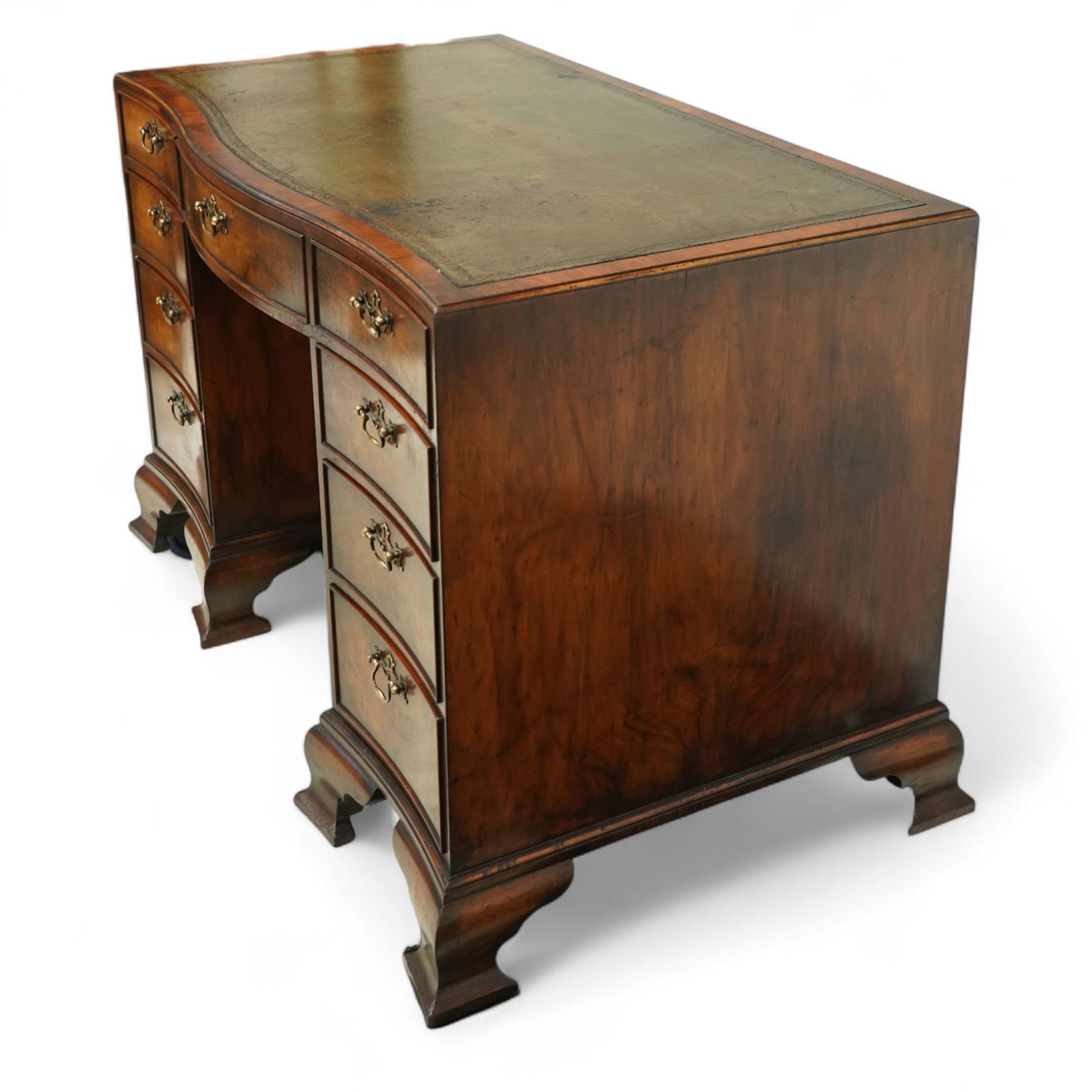 Early 20th century inlaid mahogany pedestal kneehole desk, rectangular top with inset tooled leather writing surface, over an arrangement of nine drawers with brass swan neck handles, on ogee bracket feet