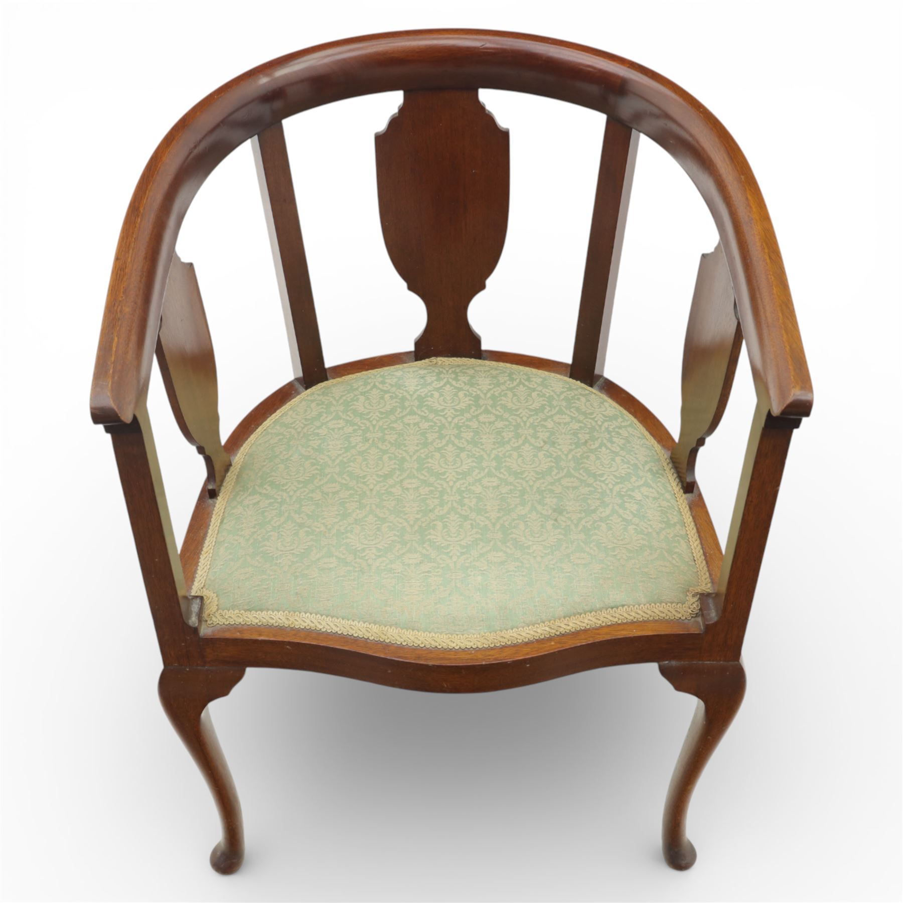 20th century mahogany tub chairs, the arched backs enclosing shaped splat panels and plain uprights, open curved arms flowing into the seat rails, upholstered seats in green foliate patterned fabric, on cabriole legs