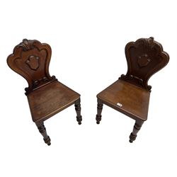 Pair of Victorian mahogany hall chairs, shaped moulded back carved with cartouche, moulded seat on turned front supports
