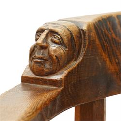 Mouseman - important oak monks chair, c1930s, the curved back inscribed with motto 'Cum Bona Voluntate Servientes' (serving with goodwill) over Trinity College Cambridge coat of arms, the shaped arms terminating with carved monks heads, each pierced side panel with Yorkshire Rose, tan leather seat on four octagonal legs joined by a cross stretcher, the back of the chair with initials ECH, with carved mouse signature, by Robert Thompson of Kilburn