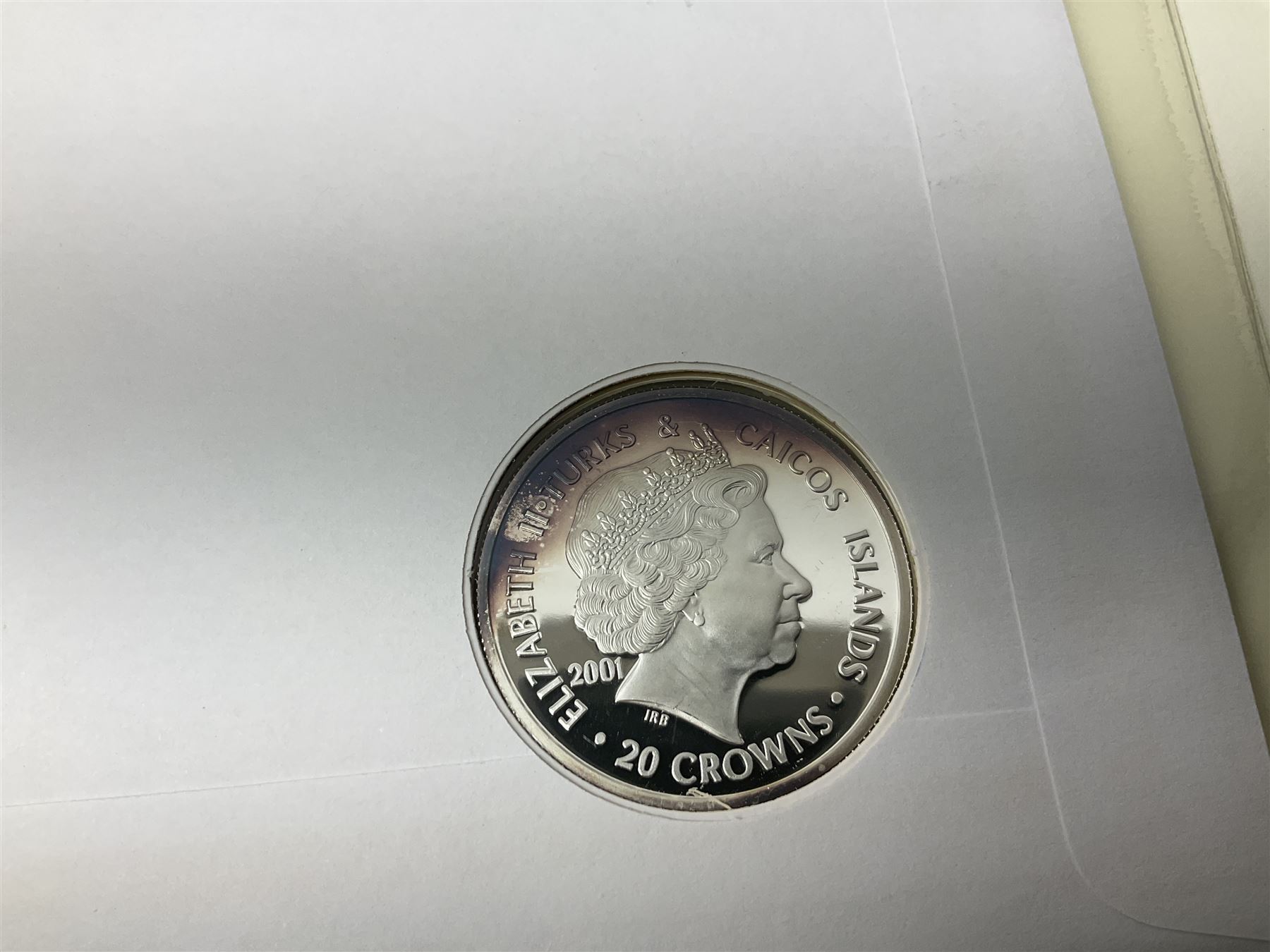 Four coin covers, comprising 2000 'The Queen Mother's 100th Birthday Silver Coin & Banknote Cover' limited edition 56/500, 2000 'Charles Darwin Commemorative Coin & Banknote Cover' limited edition 68/500, 2001 'Celebrating the 100th Birthday of Her Majesty The Queen Mother' containing  a 1999 silver one pound coin and 2001 'Royal Navy Submarines 100th Anniversary Cover' containing 2001 Turks & Caicos Islands 20 crowns silver coin