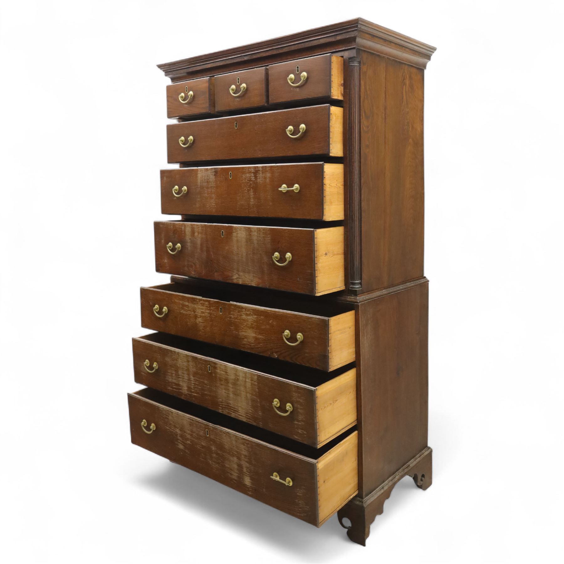 Mid 18th century oak tallboy chest, the projecting cavetto-moulded cornice over two short and three long drawers to the upper section, the lower section with three further graduated long drawers, each drawer with oak linings and fitted with later brass swan-neck handles, flanked by stop-fluted quarter columns, all raised on shaped bracket feet