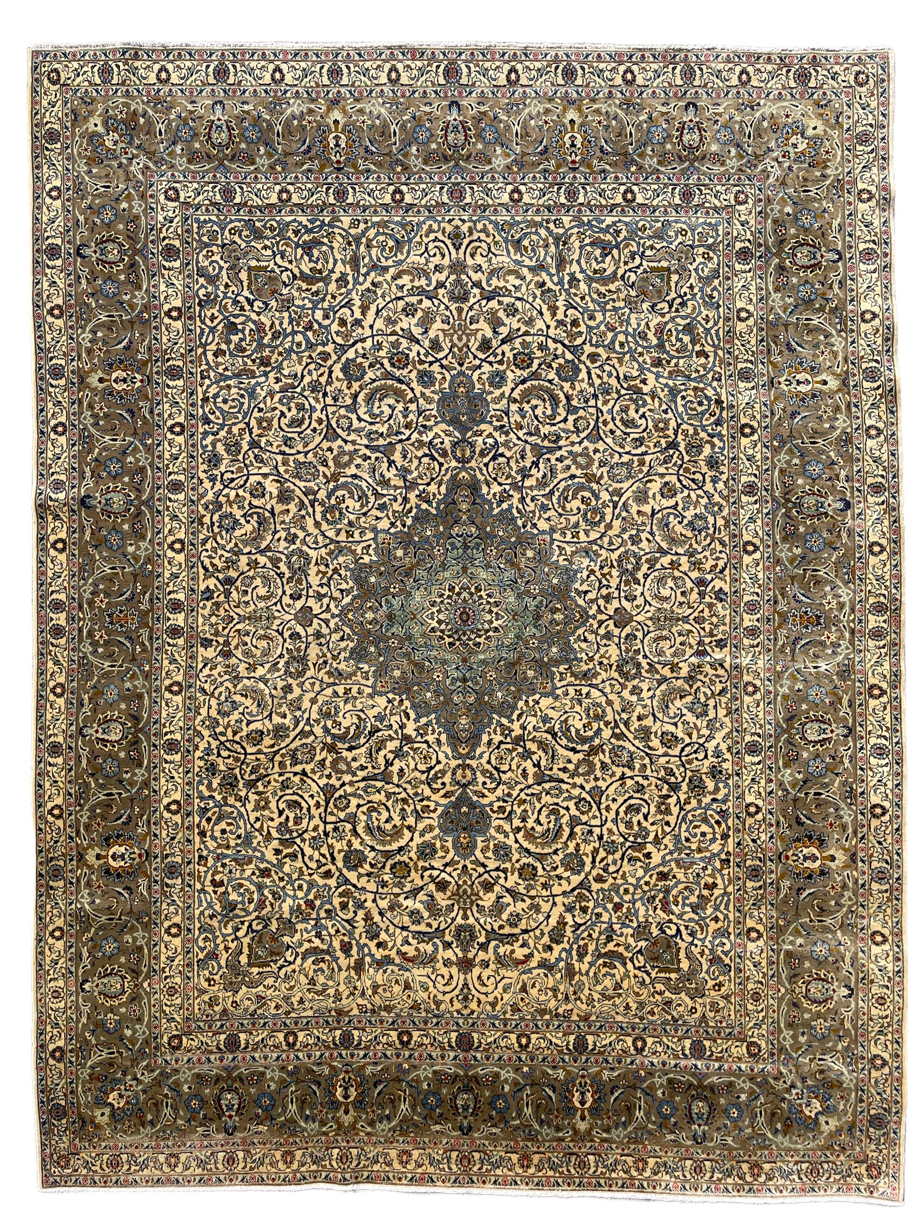Persian Meshed carpet, ivory ground and decorated with intricate floral design with trailing scrolled branch, the central medallion decorated with stylised plant motifs, seven band border, the main band decorated with scrolls and flower head motifs