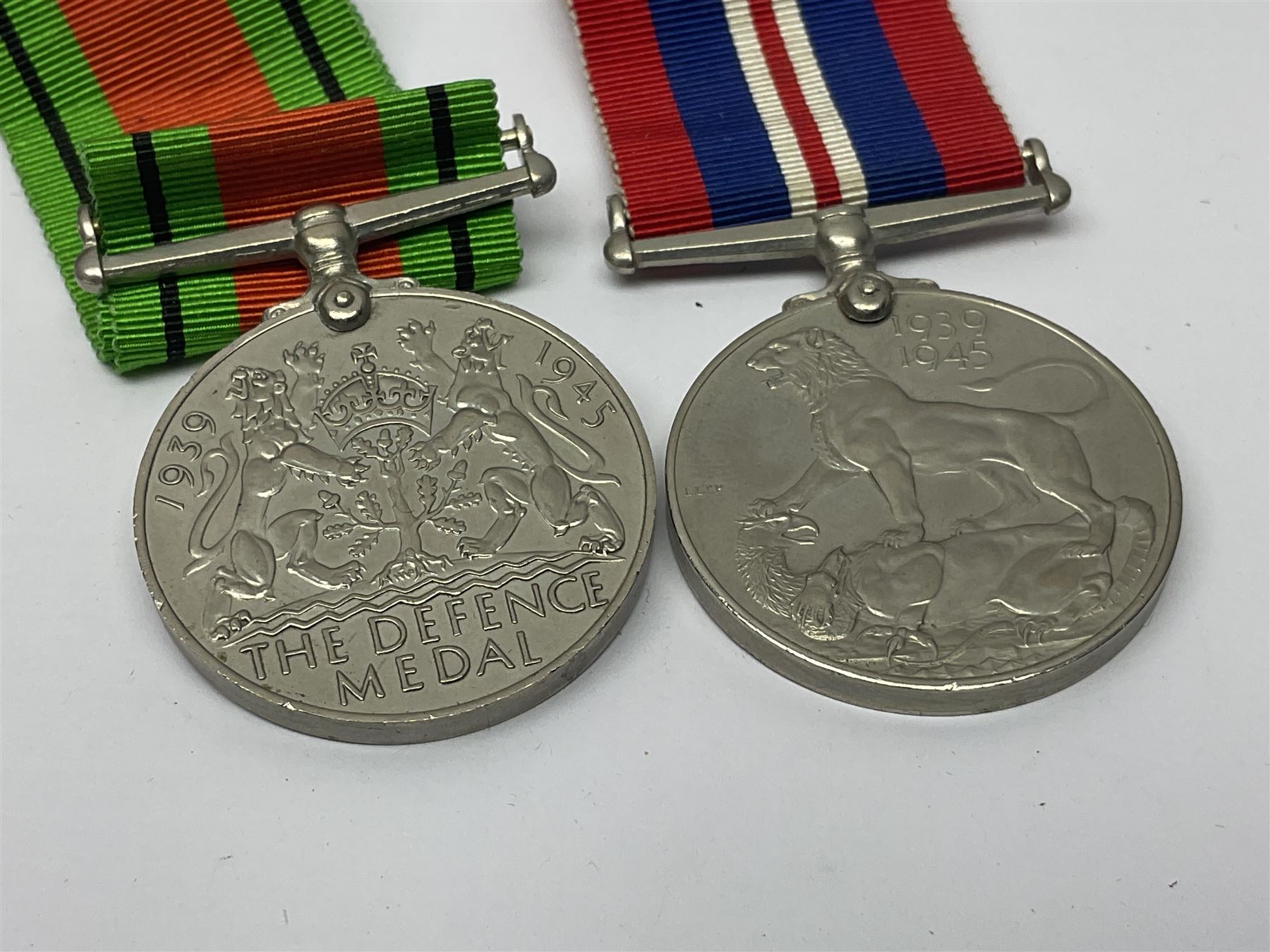 WWI pair of medals comprising British War Medal and Victory Medal awarded to 32682 Pte. W. Meadows W. Rid. R. in issue box; WWI pair of medals comprising 1914-15 Star and Victory Medal awarded to 3720 Pte. (later Cpl.) E. Petty W. York. R. with issue letter from Tank Corps; WWII group of five medals comprising 1939-45 War Medal, Defence Medal and 1939-45, Italy and Africa Stars; all with ribbons; and book of nineteen seaman's Certificates of Discharge to cook Charles Filburn 1893 - 1901 from various British ports