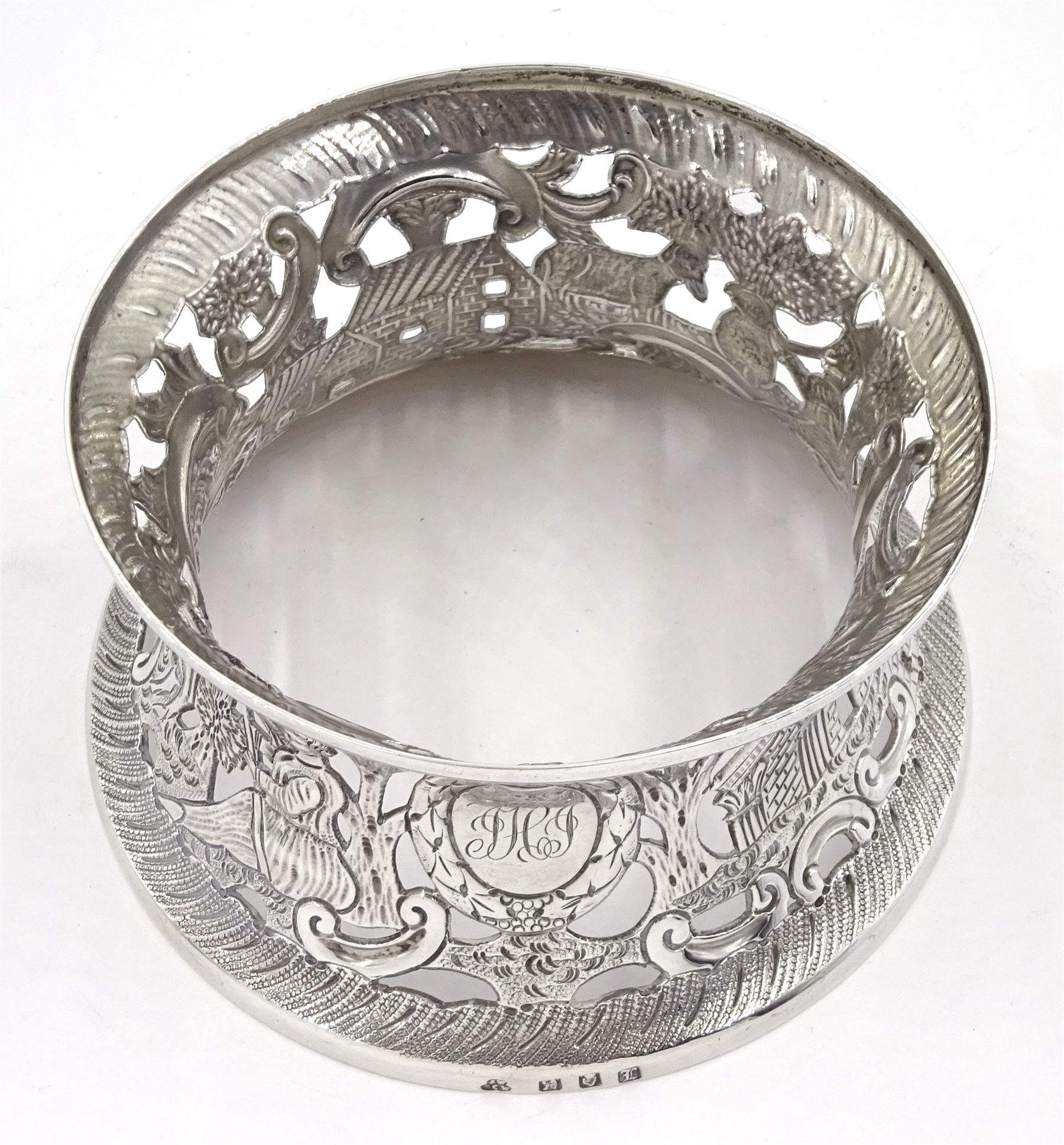 Edwardian Irish silver dish ring, of circular waisted form, embossed and pierced throughout with scene of figures, birds, cattle and buildings amidst C scrolls, hallmarked James Wakely & Frank Clarke Wheeler, Dublin 1906, upper rim D10cm, approximate weight 4.11 ozt (128 grams)