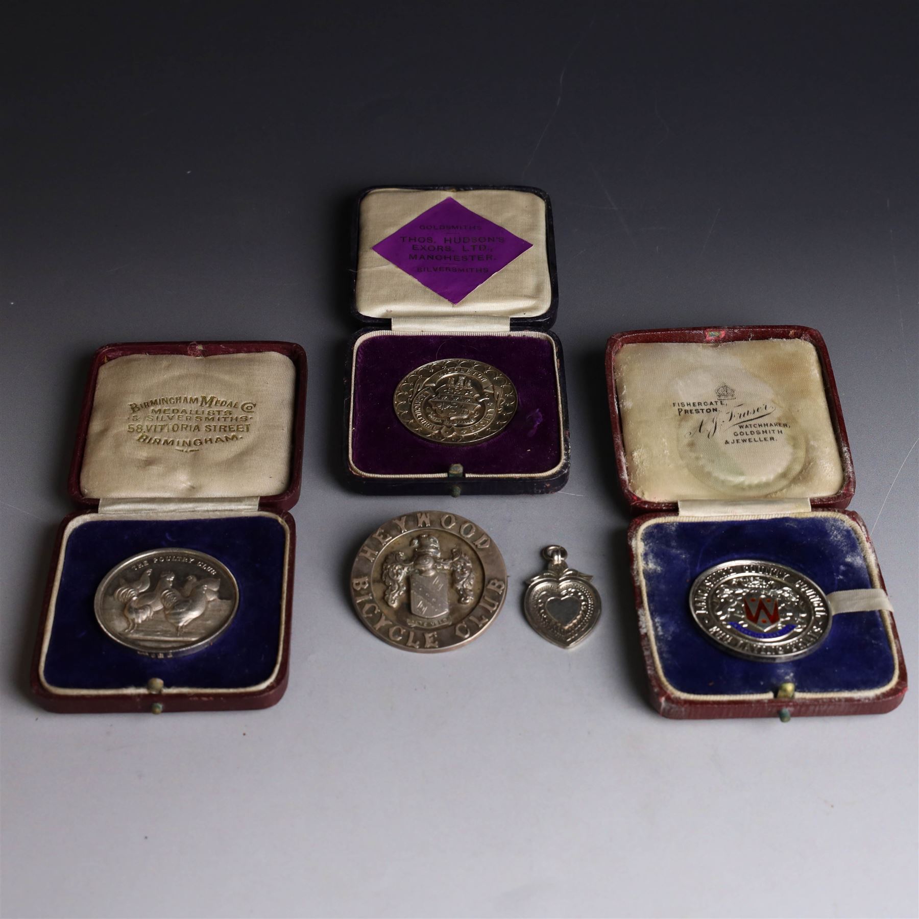 Collection of silver medals, mainly with an agricultural theme, including Poultry Club, Heywood Bicycle Club, heart shaped fob, four within leather cases 