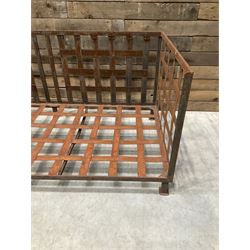 Wrought iron strapwork garden day bed, lattice back and sides