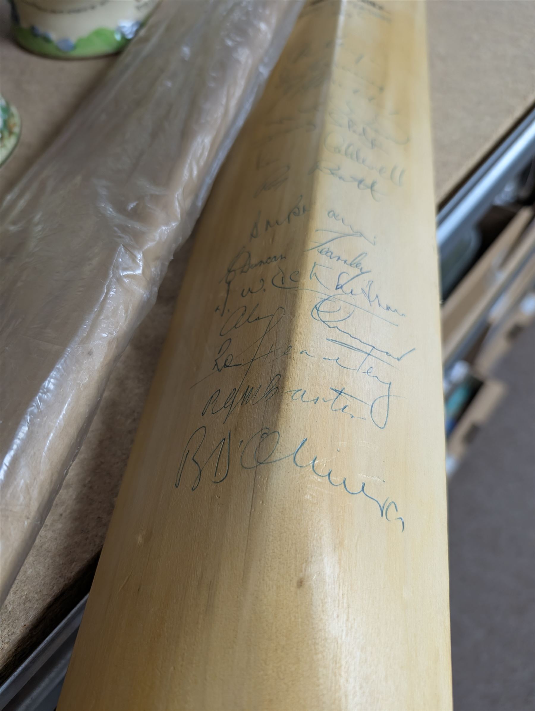 Two signed cricket bats, with signatures including Colin Cowdrey