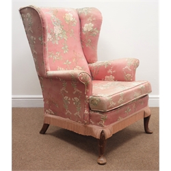  Parker Knoll wingback armchair, upholstered in a pink floral fabric, cabriole feet, W77cm  
