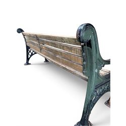 Neoclassical design cast iron and oak slatted garden bench, the twin end supports in the form of a Sphinx with acanthus carved knees and large paw feet, the pierced lattice bracket with Yorkshire rose motifs
