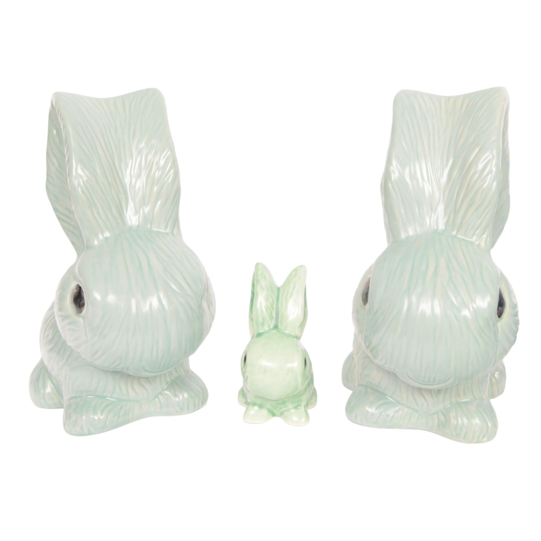 Nine Sylvac rabbits, including models 1028, 990, 1026 etc, in blue and green, largest H25cm  