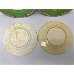 Set of four early 19th century plates, hand painted with birds within green and gilt ornate border D24cm
