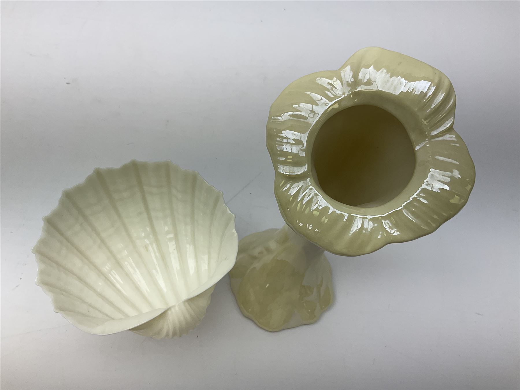 Quantity of Belleek ceramics to include mid-late 19th century jug moulded with green man mask and foliage, date code stamp for 1863-1890, together with later Belleek cornucopia shape vase, jug and other vases together with a Belleek style shell dish raised on branches, tallest H19cm