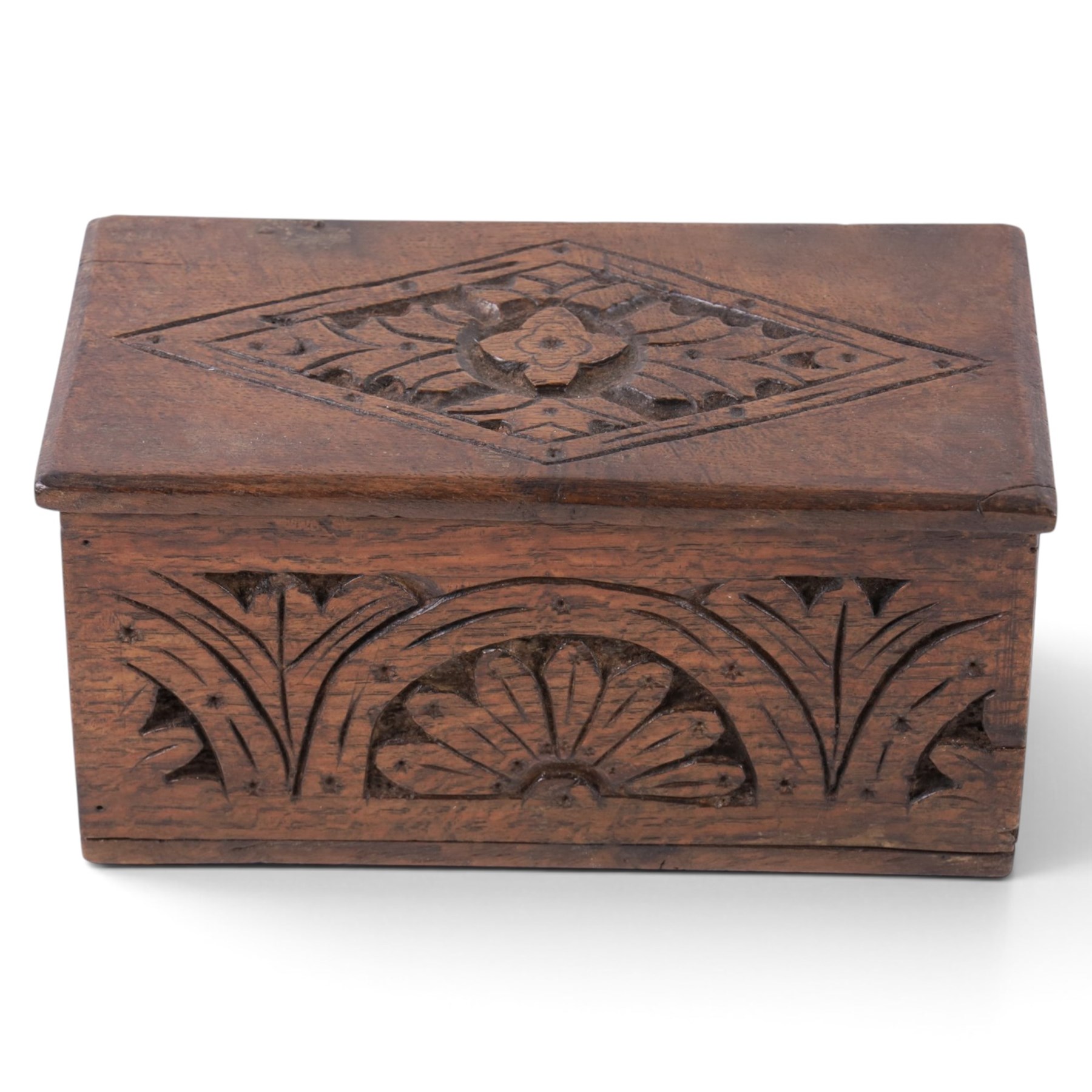 Carved oak box, the hinged lid with a carved diamond motif, the sides and front carved with stylised flowers, H12cm, L24cm