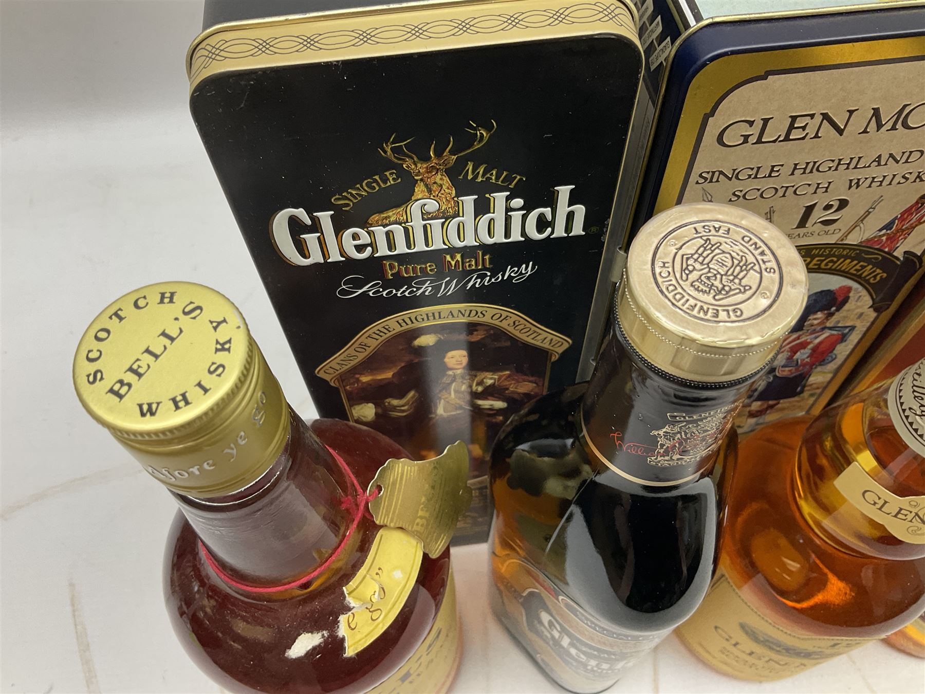 Glen Moray 12 Year Single Malt Highland Scotch Whisky, 70cl 40% vol, one bottle, in Highland Regiments The Black Watch presentation tin, Glenfiddich Pure Malt Scotch Whisky, Special Old Reserve, 70cl 40% vol, one bottle, in Clan Murray presentation tin, Bell's Extra Special Old Scotch Whisky, Aged 8 Years, 70cl 40% vol, one bottle, in box and Bell's Extra Special Old Scotch Whisky, 1l, 43% vol (4)