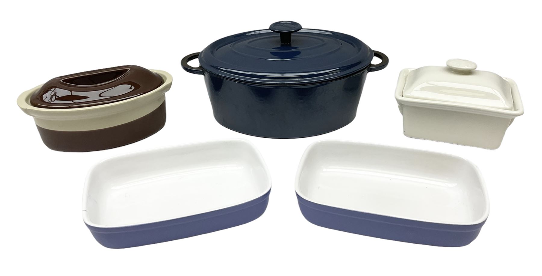 Emile Henry covered casserole dish of oval form in two tone brown and cream, no. 03.06, together with cast iron Nomar twin handled lidded casserole dish of oval form in navy, and other ovenware including Flintware ICTC, largest L35cm