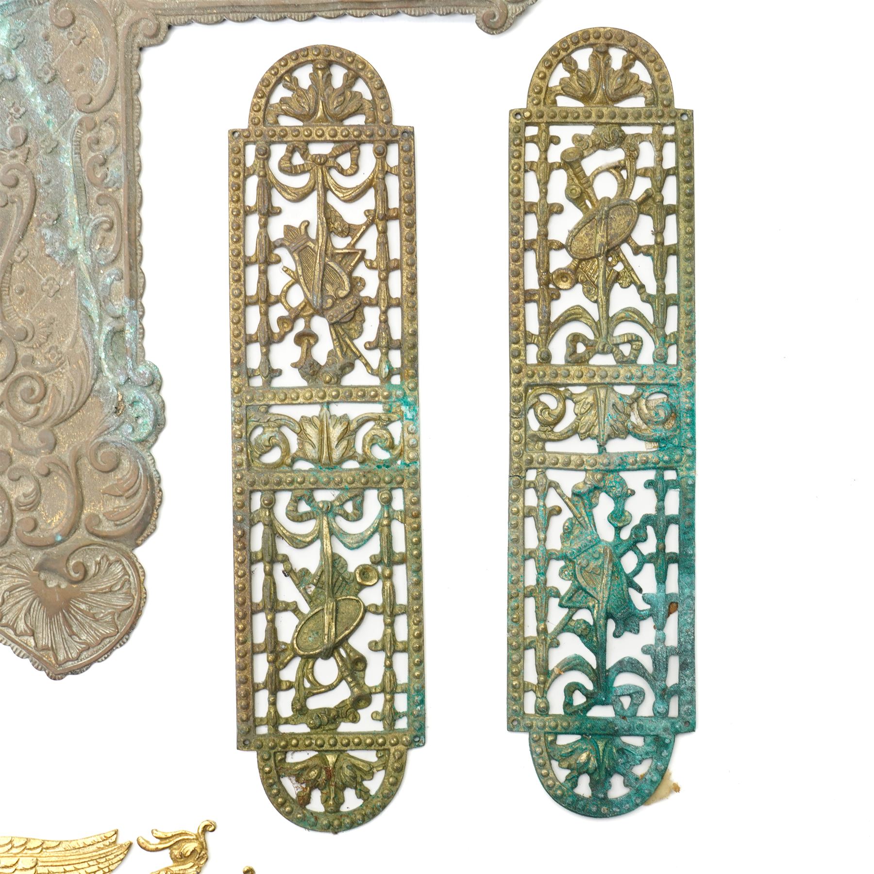 Large Victorian embossed brass door plate by Turner & Fowle with circular handle L63cm , pair of period design gilt brass door plates with oval handles, two more pairs of brass door plates and pair of brass door handles  
Provenance: property of a Nobleman