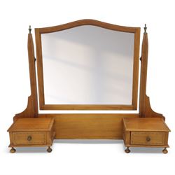 Two early 20th century mahogany swing dressing mirrors, comprising one with arched rectangular plate in a moulded frame on shaped supports, flanked by two inlaid trinket drawers (H 69cm, W 88cm, D 20cm), together with another rectangular plate mirror on turned supports upon bun feet (H 58cm, W 48cm, D 23cm)