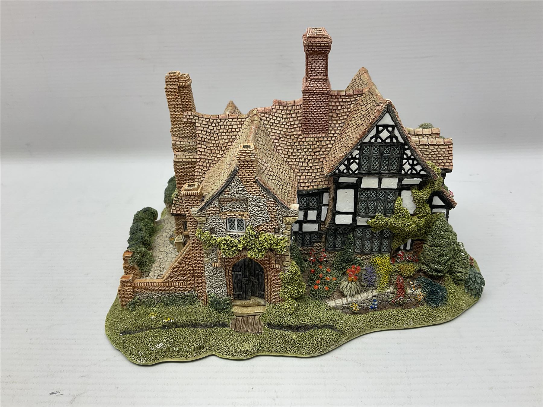 Three Lilliput lanes, comprising Oakwood Smithy, Anne of Cleves and Bluebell Farm, all with deeds and original boxes 